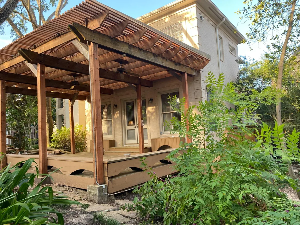 Wood pergola patio cover with stained posts and beams
