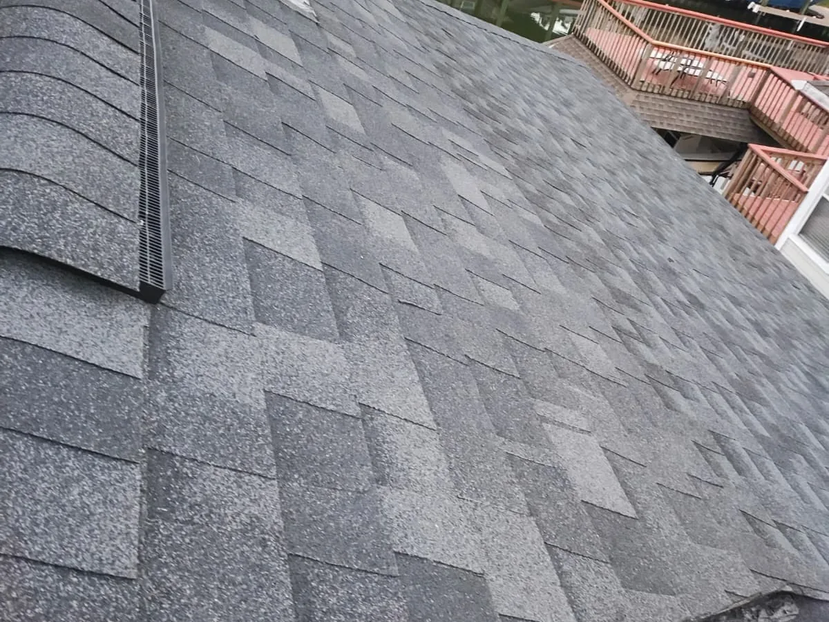 Gray architectural asphalt shingles across a sloped roof section